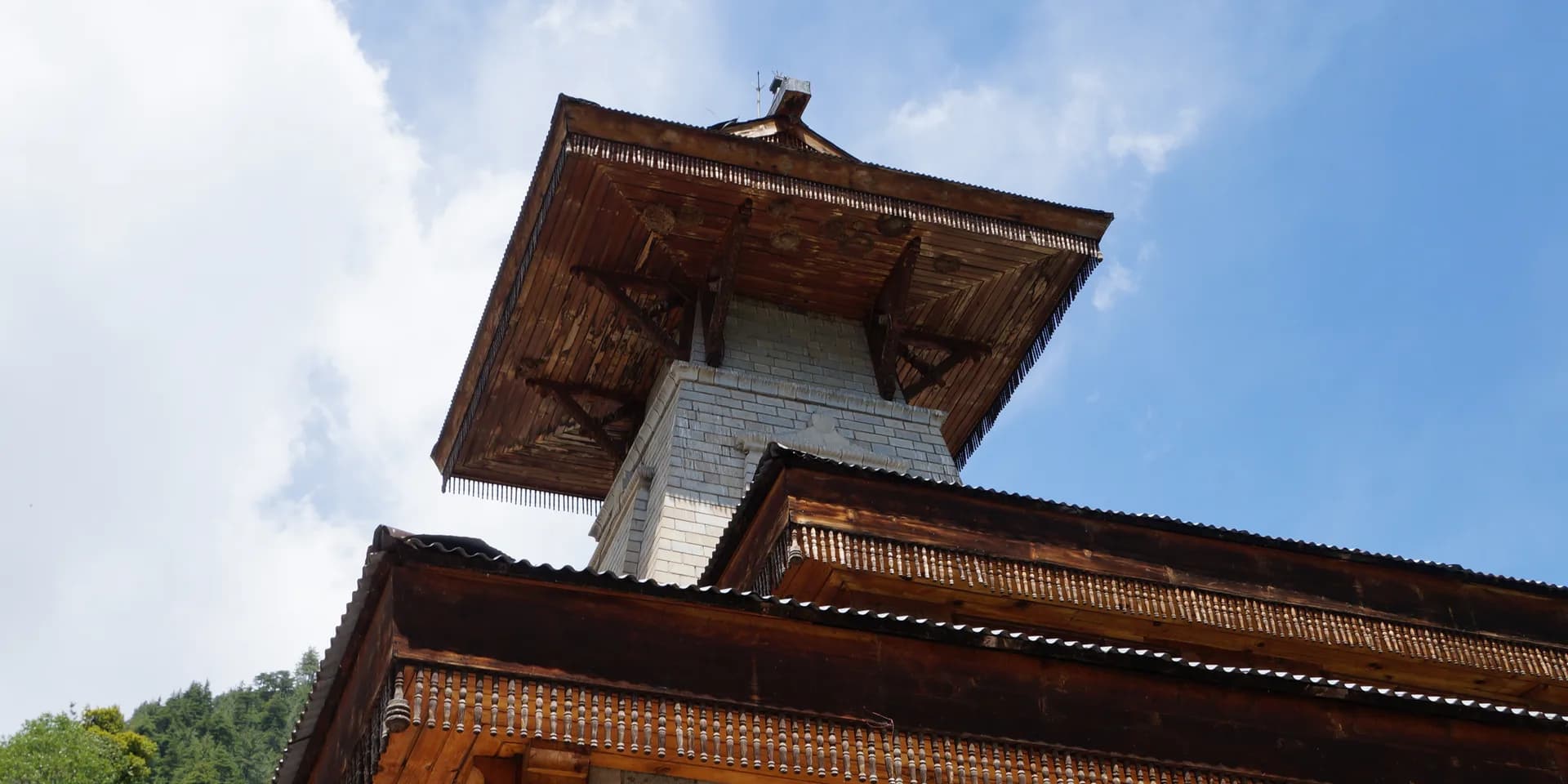 Wooden roof and stone walls of Manu Temple in Old Manali