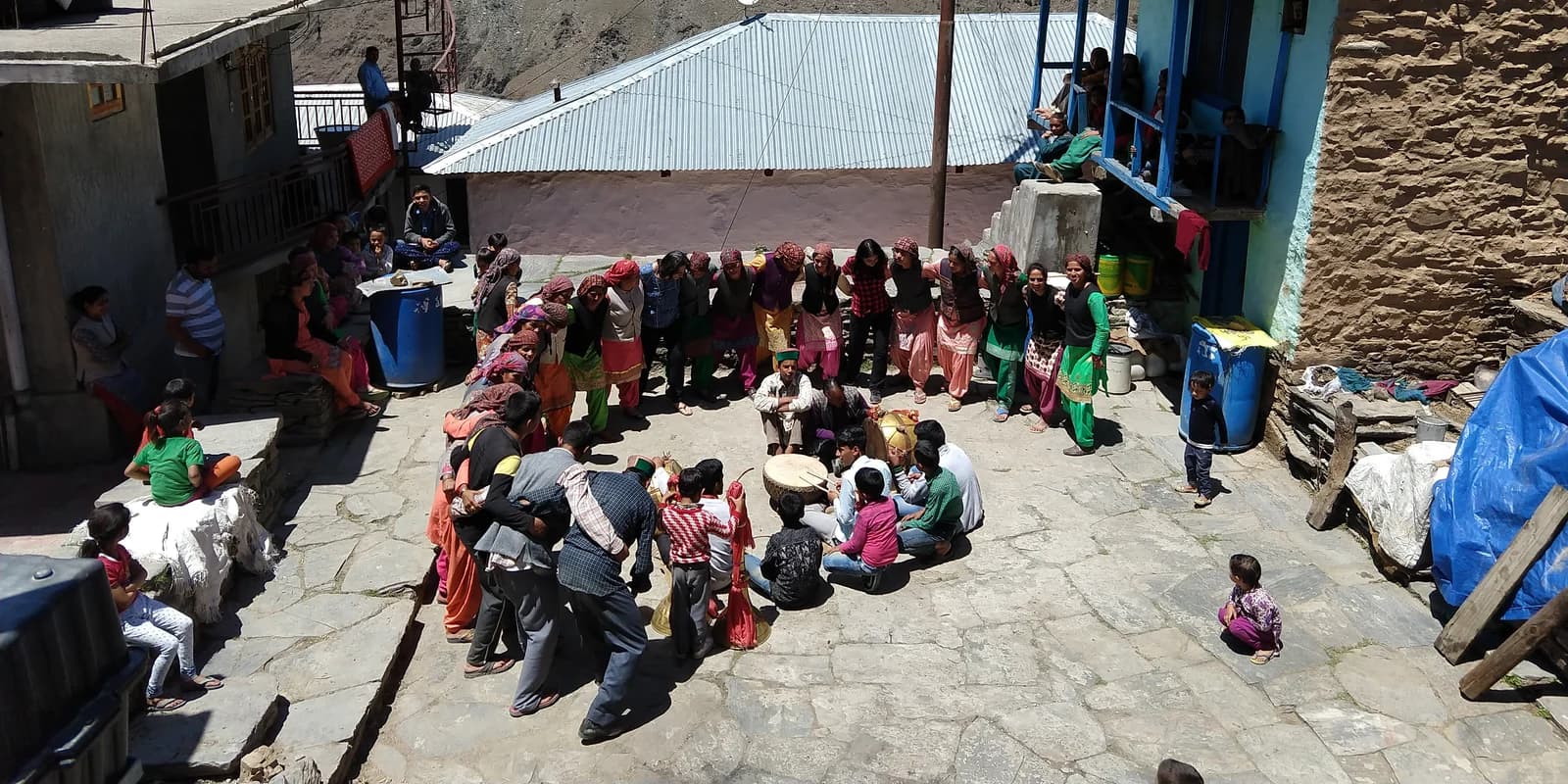 Nati dancers and musicians gathered in a village square in Kullu district