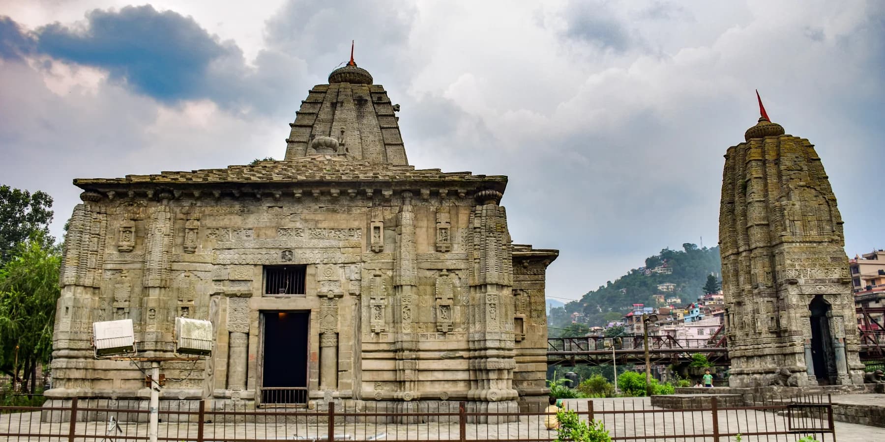 Carved stone shrine and smaller tower at Panchvaktra Temple in Mandi