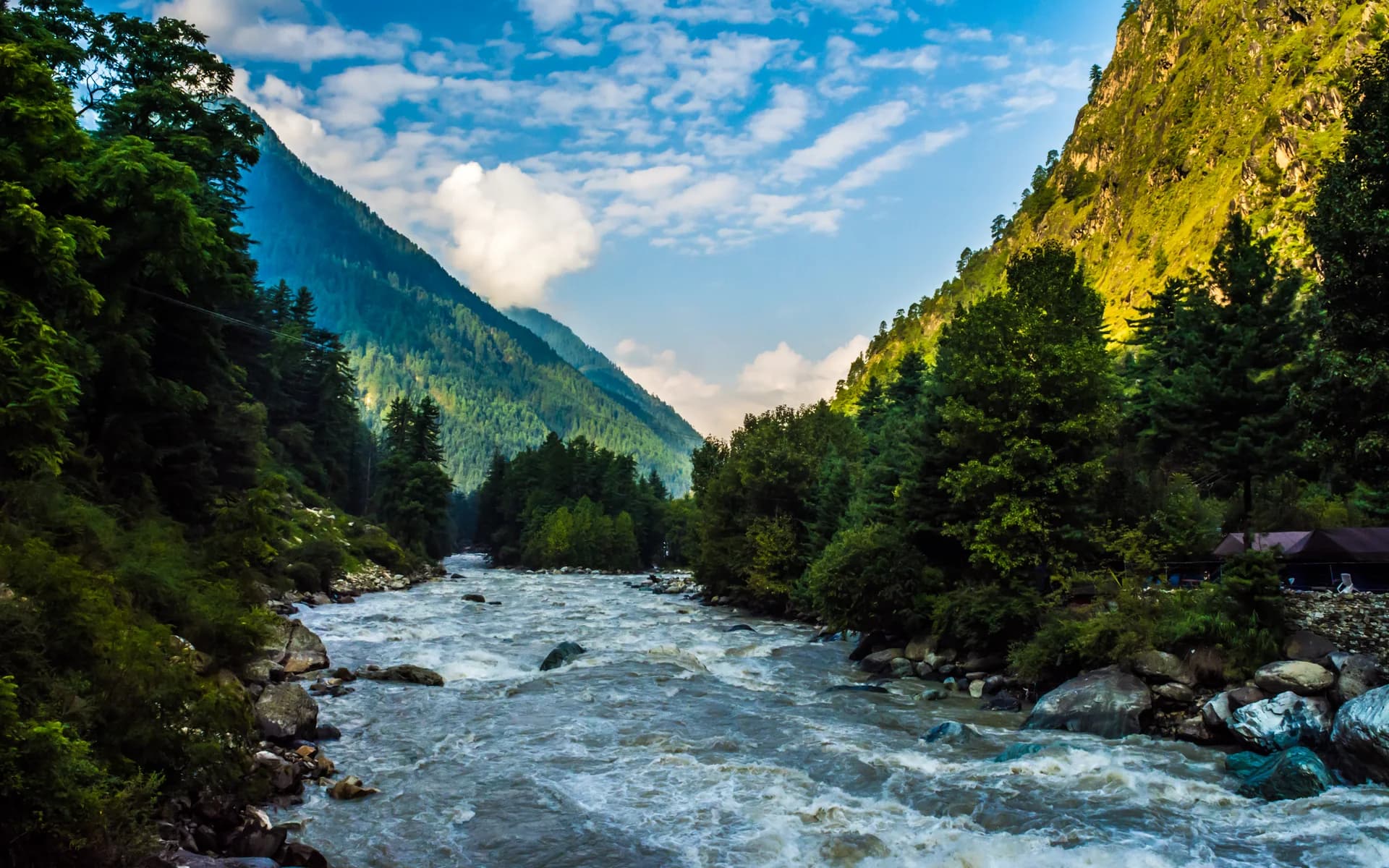 Parvati River flowing between forested slopes at Kasol