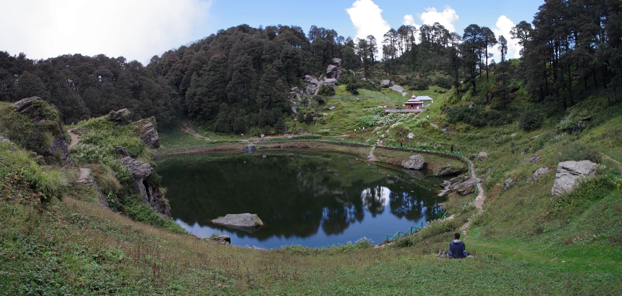 Serolsar Lake, its forested banks and a small temple near Jalori Pass